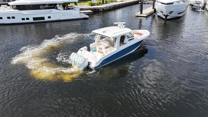 Yacht Kings Yacht Photos Pics 2020 Boston Whaler 350 Realm cruising in marina, surrounded by yachts.