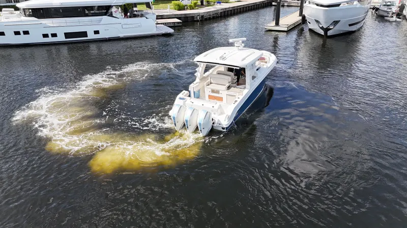 Yacht Kings Yacht Photos Pics 2020 Boston Whaler 350 Realm maneuvering in marina, creating circular water pattern.