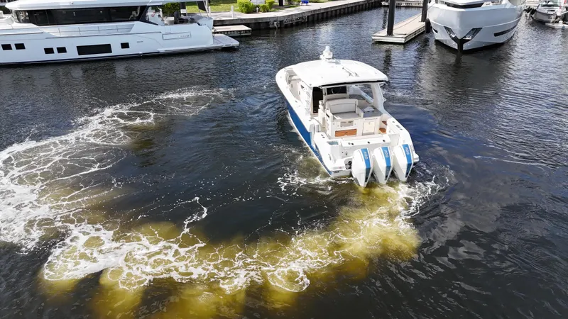 Yacht Kings Yacht Photos Pics 2020 Boston Whaler 350 Realm boat navigating marina waters with visible wake.