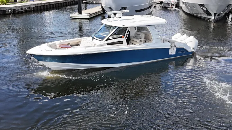Yacht Kings Yacht Photos Pics 2020 Boston Whaler 350 Realm boat cruising in a marina.