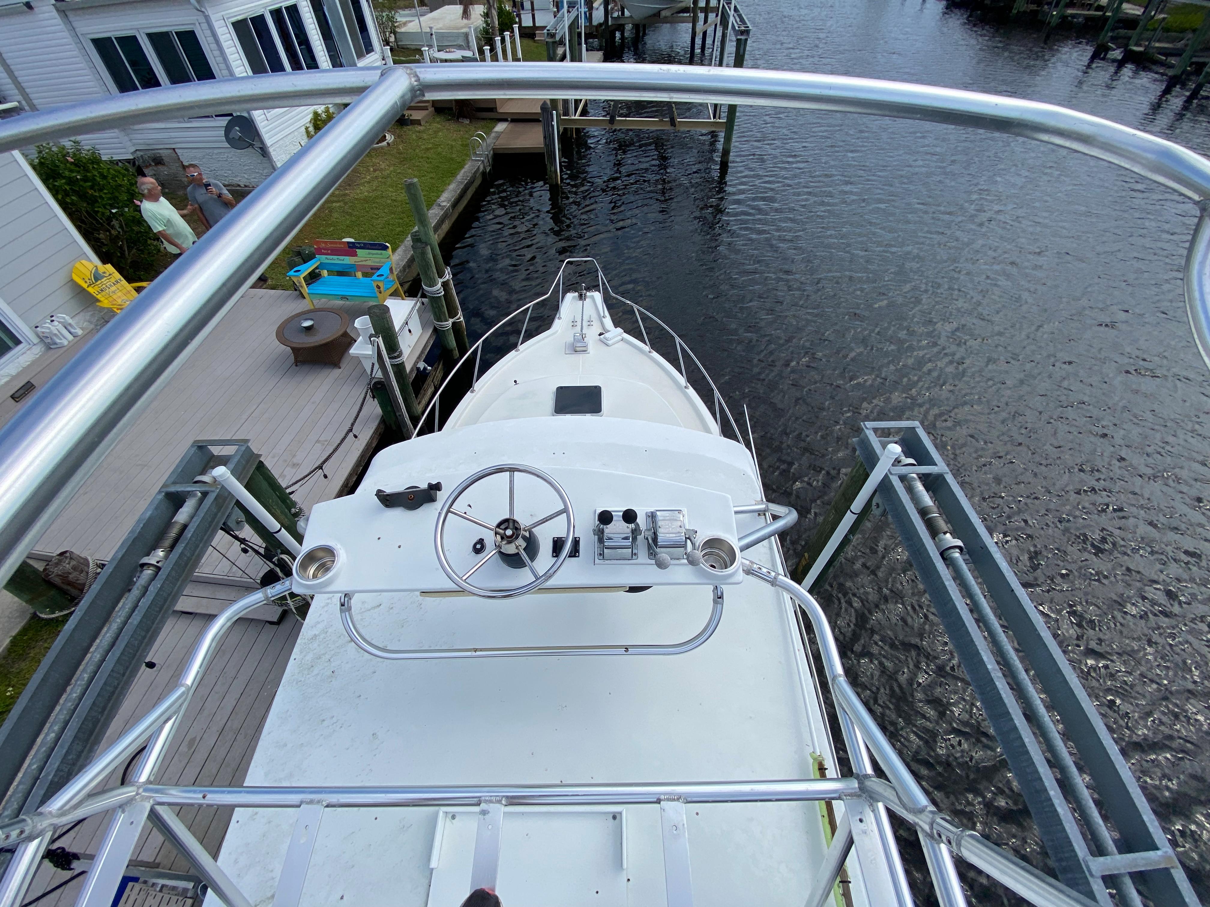 View from the upper deck of a 1997 Stamas 310 Express boat docked by a waterfront.