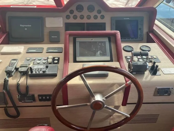 Vintage Yacht Photos Pics Helm of 2006 Guy Couach 2100 yacht with navigation equipment and steering wheel.