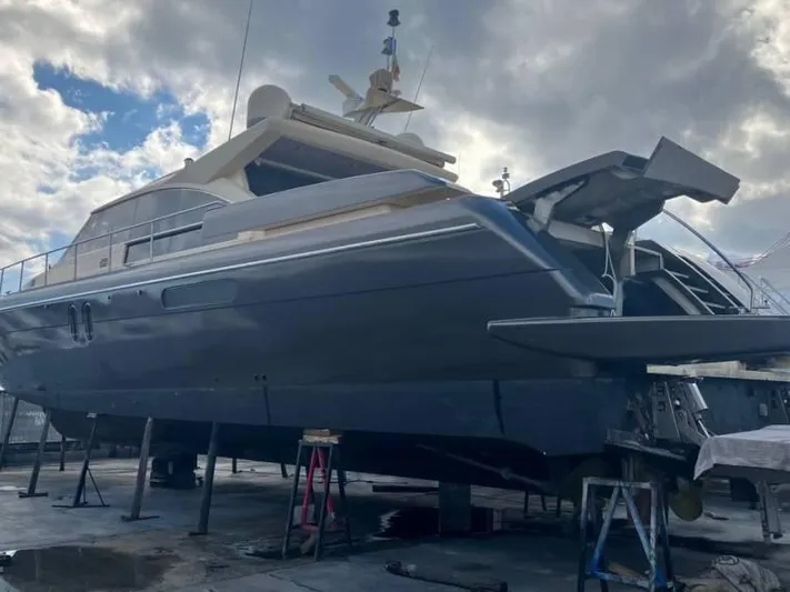 Vintage Yacht Photos Pics 2006 Guy Couach 2100 yacht on dry dock under cloudy sky.