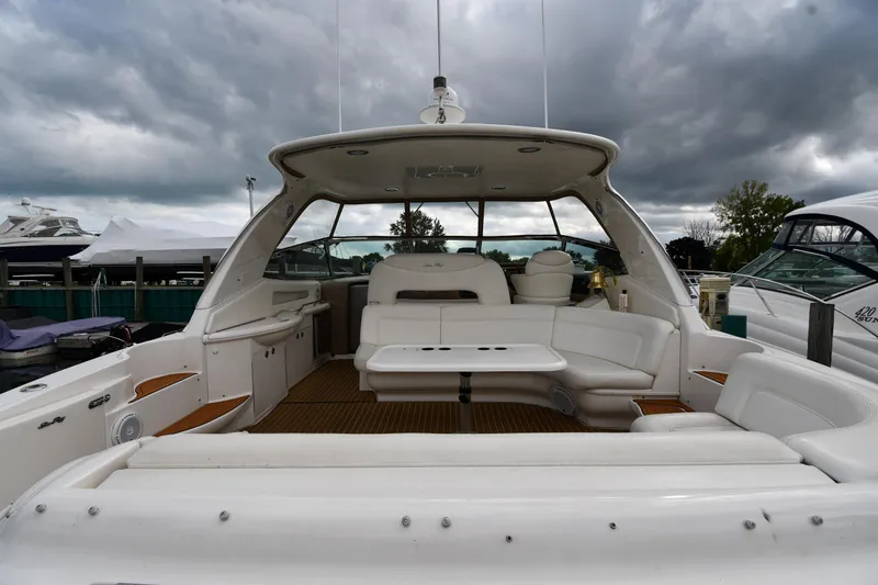  Yacht Photos Pics 2003 Sea Ray 460 Sundancer yacht with spacious seating under cloudy skies.