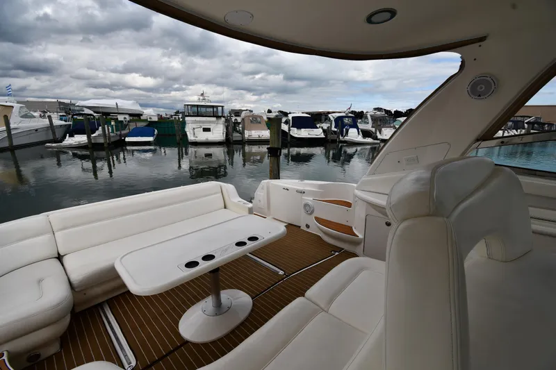  Yacht Photos Pics 2003 Sea Ray 460 Sundancer yacht interior with marina view, featuring white seating and table.