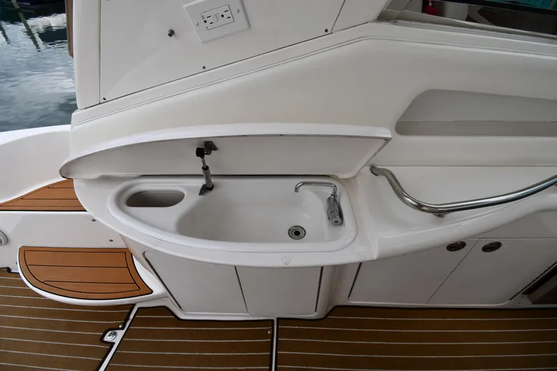  Yacht Photos Pics 2003 Sea Ray 460 Sundancer yacht sink area with wooden deck flooring.