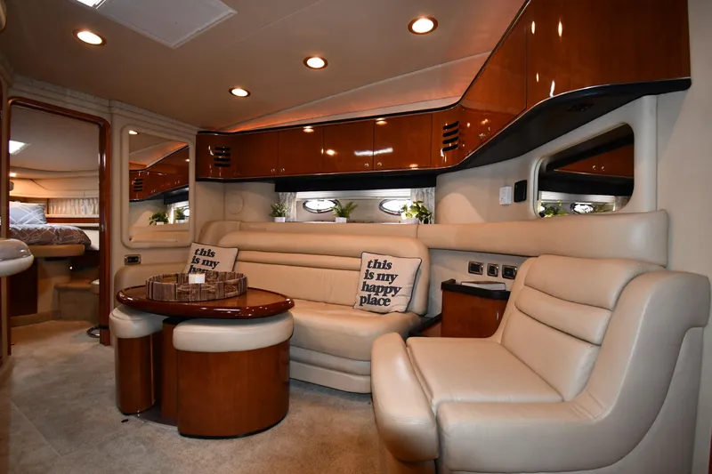  Yacht Photos Pics Luxurious interior of 2003 Sea Ray 460 Sundancer yacht with plush seating and elegant wood finishes.