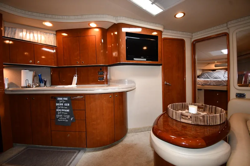  Yacht Photos Pics 2003 Sea Ray 460 Sundancer interior with kitchen, TV, and seating area.