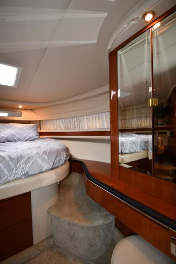  Yacht Photos Pics Interior of 2003 Sea Ray 460 Sundancer yacht, featuring a cozy bedroom with elegant wood finishes.