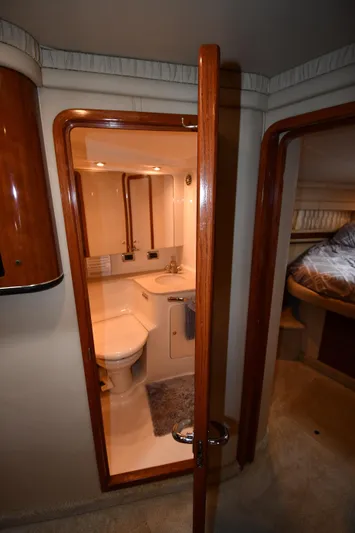  Yacht Photos Pics Interior of 2003 Sea Ray 460 Sundancer yacht, featuring a compact bathroom and cozy bedroom.