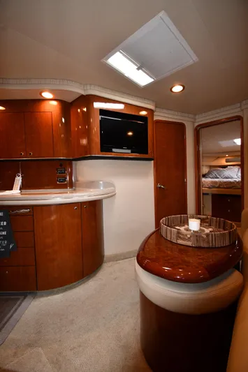  Yacht Photos Pics Luxurious interior of 2003 Sea Ray 460 Sundancer yacht with wood cabinetry and modern amenities.