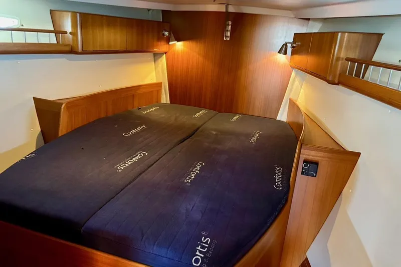  Yacht Photos Pics Luxurious cabin interior of 2006 X-Yachts X-50 with comfortable bedding and wooden finish.
