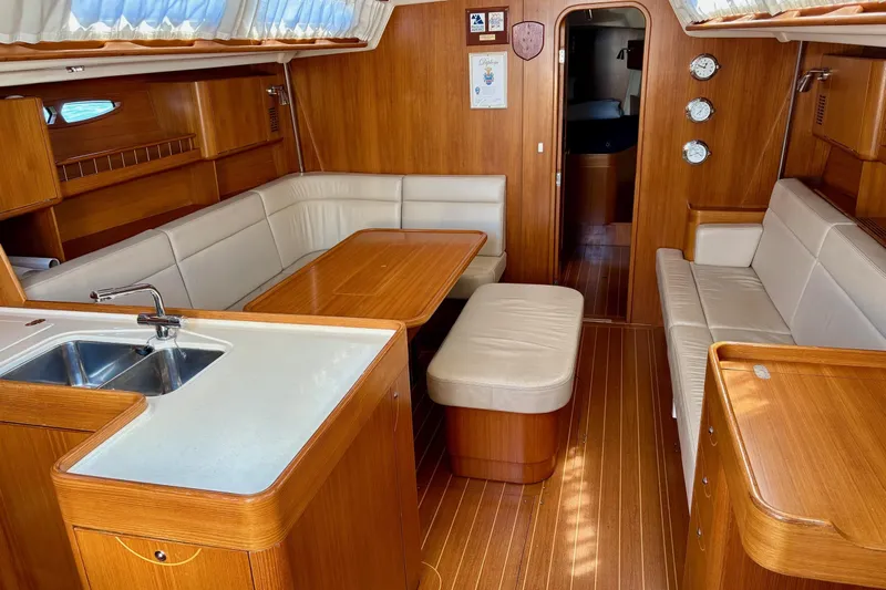  Yacht Photos Pics Luxurious 2006 X-Yachts X-50 interior with elegant wood finish and cozy seating area.