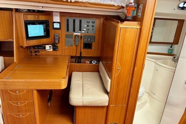  Yacht Photos Pics Interior of 2006 X-Yachts X-50 sailboat with navigation station and wooden cabinetry.
