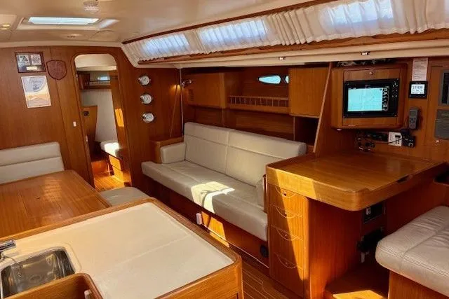  Yacht Photos Pics Luxurious 2006 X-Yachts X-50 interior with wood finish, seating, and navigation equipment.