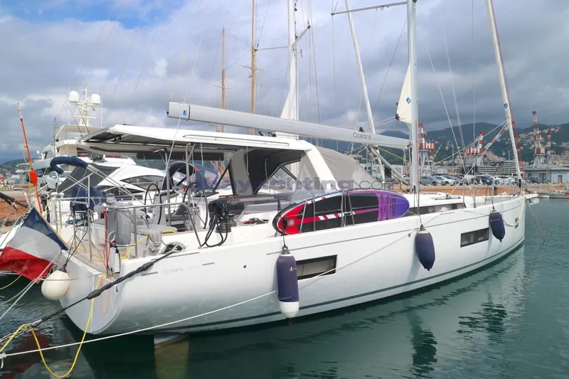  Yacht Photos Pics 2023 Beneteau Oceanis 54 yacht docked in a marina, featuring sleek design and modern amenities.