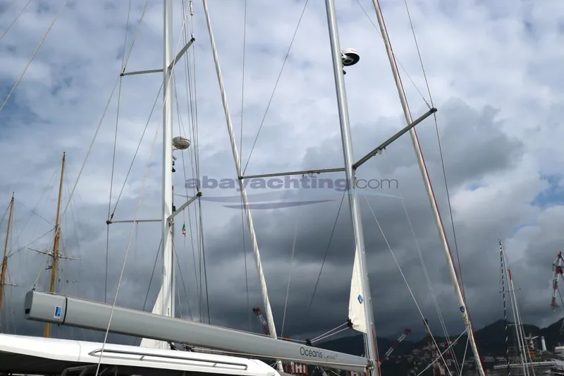  Yacht Photos Pics Sailboat mast of 2023 Beneteau Oceanis 54 against cloudy sky.
