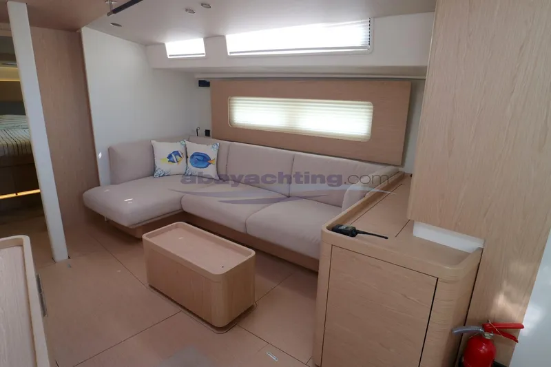  Yacht Photos Pics Modern interior of 2023 Beneteau Oceanis 54 yacht with cozy seating and elegant design.
