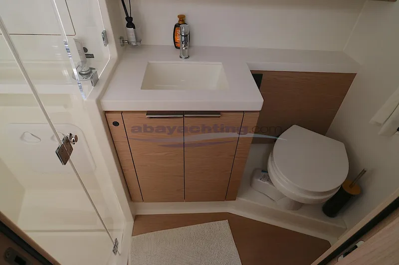  Yacht Photos Pics Modern bathroom in 2023 Beneteau Oceanis 54 yacht with sink and toilet.
