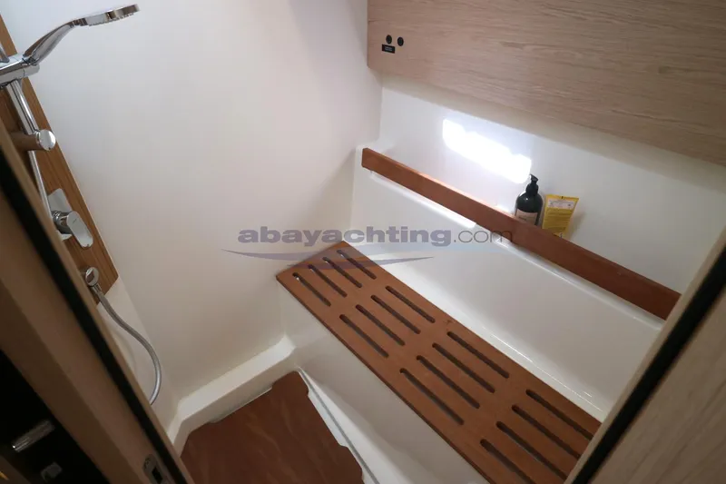  Yacht Photos Pics 2023 Beneteau Oceanis 54 yacht bathroom with wooden bench and modern shower.