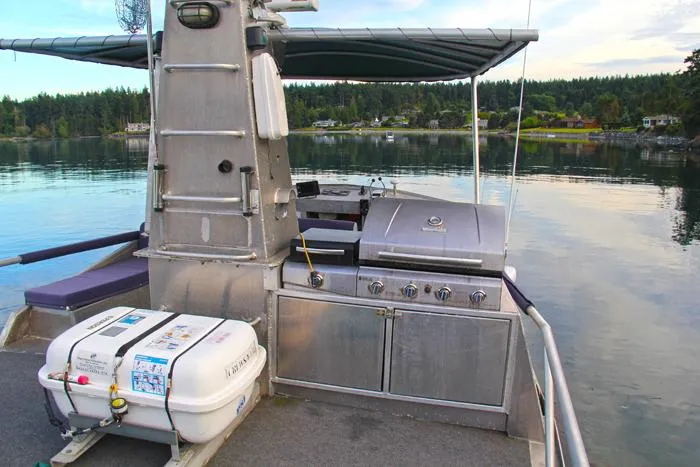 Lone Wolf Yacht Photos Pics Custom 2002 Carlson Marine Trawler with outdoor grill and life raft on calm water.