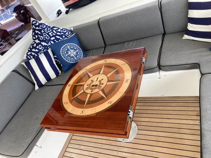 The Recipe Yacht Photos Pics Luxurious Lagoon 560 yacht interior with compass-themed table and nautical cushions, 2011 model.