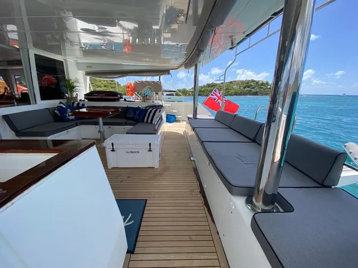 The Recipe Yacht Photos Pics Spacious deck of 2011 Lagoon 560 yacht with seating, overlooking clear blue waters.