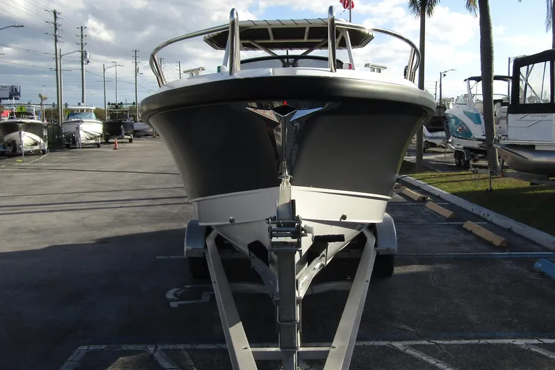  Yacht Photos Pics 2023 Windy SR28 CC boat on trailer in parking lot, front view.
