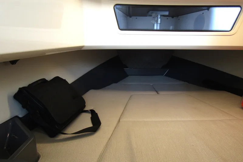  Yacht Photos Pics 2023 Windy SR28 CC cabin interior with beige seating and storage compartment.