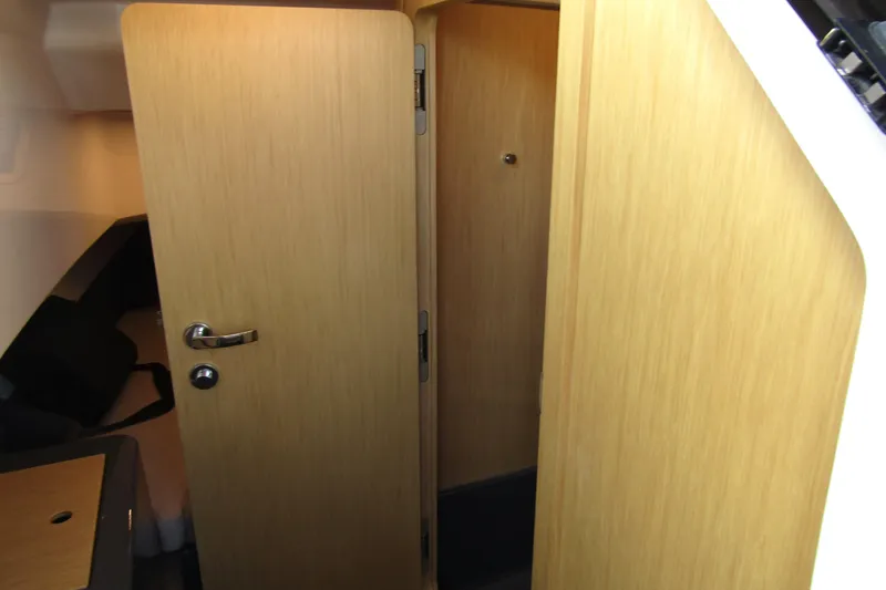  Yacht Photos Pics Interior cabin view of 2023 Windy SR28 CC, featuring wooden doors and modern design.