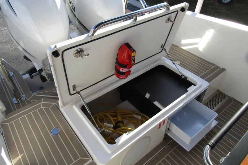  Yacht Photos Pics 2023 Windy SR28 CC boat storage compartment with fire extinguisher and equipment.