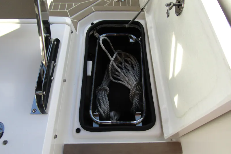  Yacht Photos Pics Open storage compartment on 2023 Windy SR28 CC boat with coiled rope inside.