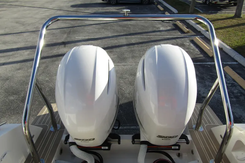  Yacht Photos Pics Twin outboard engines on 2023 Windy SR28 CC boat, parked on pavement.