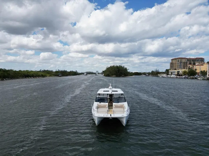 Yaffa Yacht Photos Pics Aquila 36 yacht cruising on a scenic waterway under a partly cloudy sky.