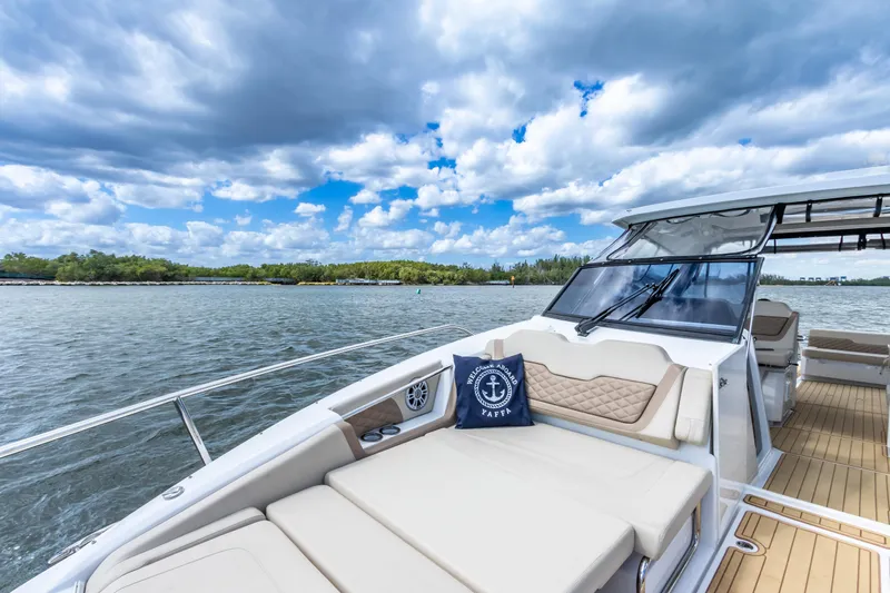 Yaffa Yacht Photos Pics Aquila 36 yacht, 2021 model, cruising on a serene lake under a partly cloudy sky.