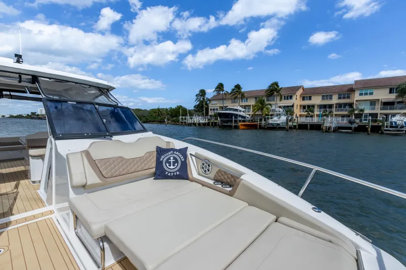 Yaffa Yacht Photos Pics Luxury Aquila 36 yacht on water, featuring spacious deck and scenic waterfront view.