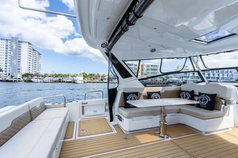 Yaffa Yacht Photos Pics 2021 Aquila 36 yacht interior with seating, table, and waterfront view.