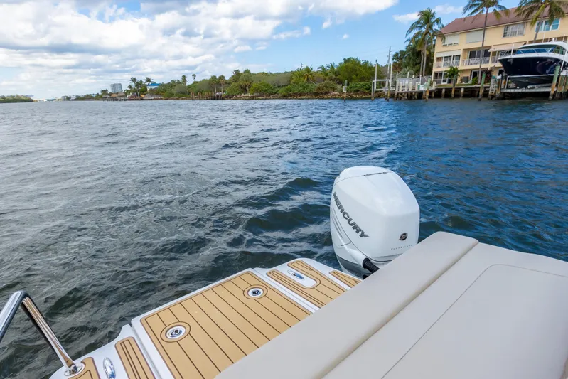 Yaffa Yacht Photos Pics Aquila 36 boat on water, featuring a Mercury outboard motor, with scenic waterfront view.