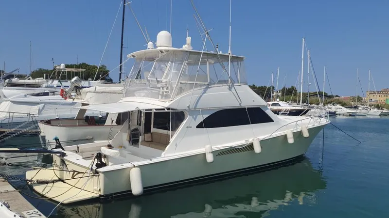 No Name Yacht Photos Pics 2008 Viking Convertible 60 yacht docked in a marina, surrounded by other boats.
