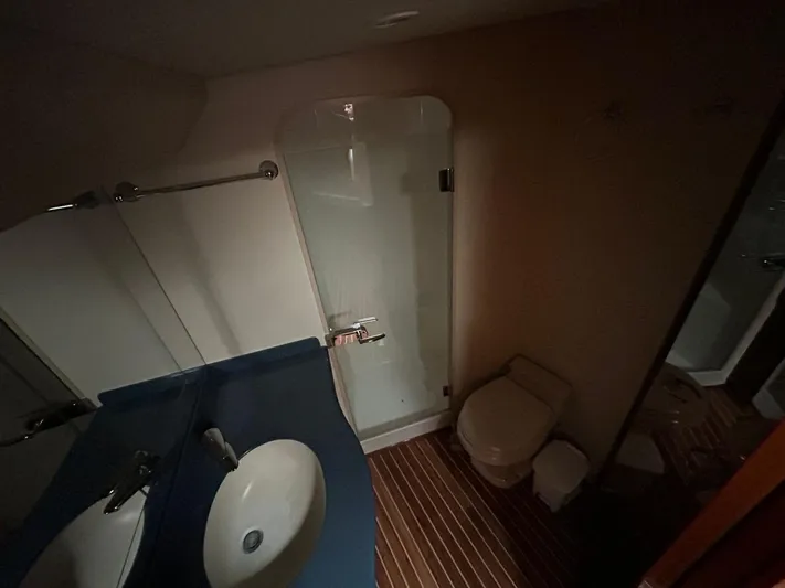 No Name Yacht Photos Pics Bathroom interior of 2008 Viking Convertible 60 yacht with shower, sink, and toilet.