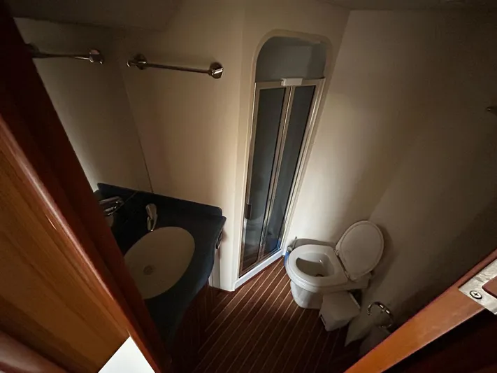 No Name Yacht Photos Pics Bathroom interior of 2008 Viking Convertible 60 yacht with shower, sink, and toilet.