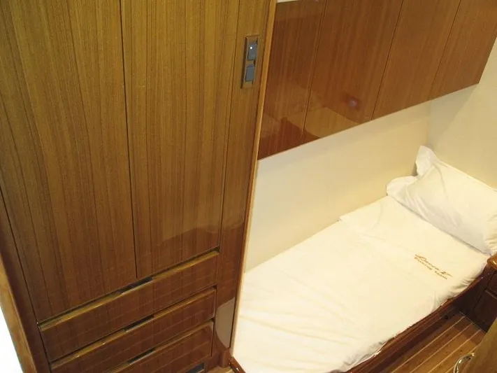 No Name Yacht Photos Pics Cozy cabin interior of 2008 Viking Convertible 60 yacht with wooden finish and single bed.