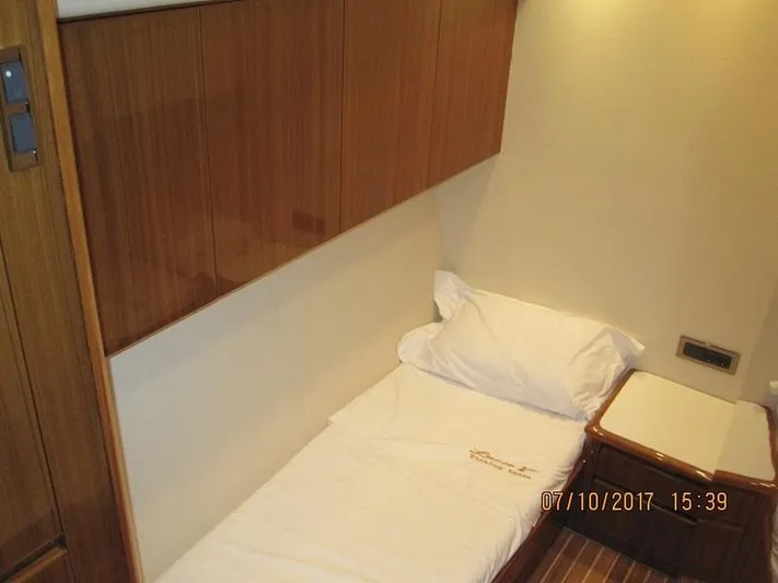 No Name Yacht Photos Pics Small cabin interior of 2008 Viking Convertible 60 yacht with single bed and wooden cabinetry.