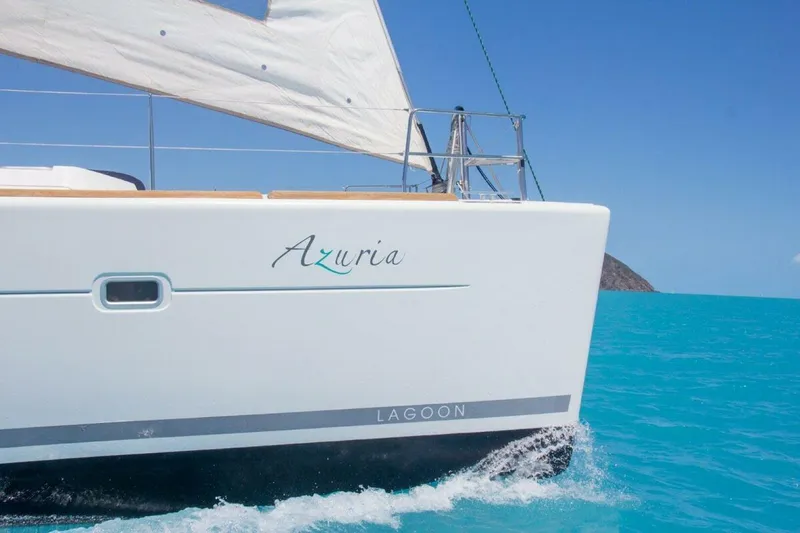 Azuria Yacht Photos Pics Sailing catamaran Lagoon 500, 2011 model, cruising in turquoise waters under clear blue skies.
