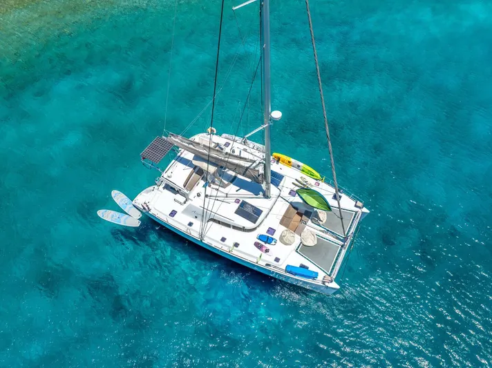Azuria Yacht Photos Pics Aerial view of 2011 Lagoon 500 catamaran on clear turquoise water.