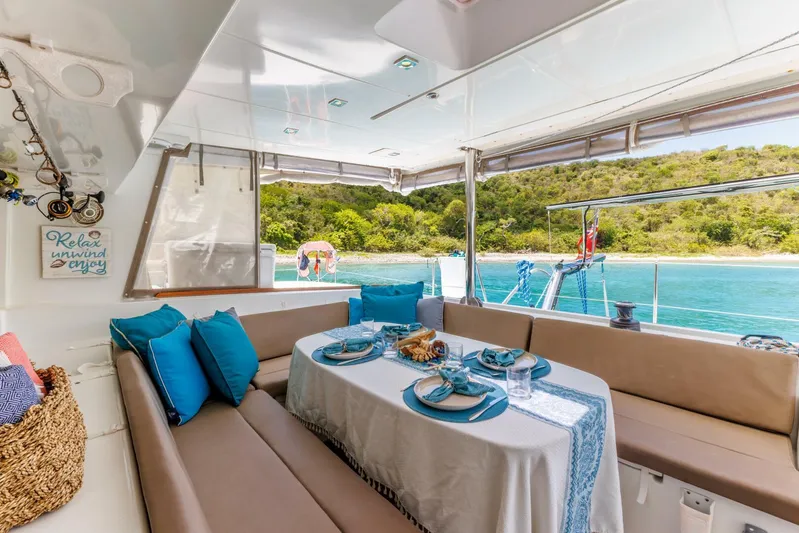 Azuria Yacht Photos Pics Luxurious Lagoon 500 yacht interior with elegant dining setup, overlooking serene turquoise waters.
