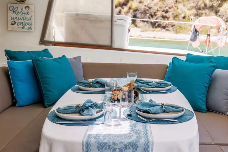 Azuria Yacht Photos Pics Elegant dining setup on Lagoon 500 yacht, featuring blue accents and coastal decor.