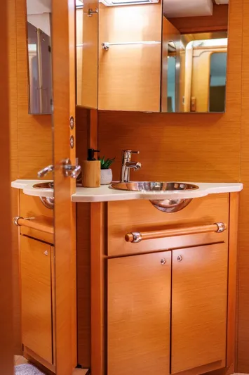 Azuria Yacht Photos Pics Luxurious bathroom in 2011 Lagoon 500 yacht with wooden cabinetry and modern fixtures.