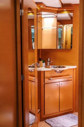 Azuria Yacht Photos Pics Interior of 2011 Lagoon 500 yacht bathroom with wooden cabinetry and modern sink.