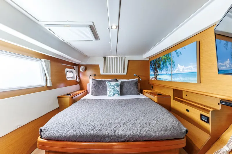 Azuria Yacht Photos Pics Luxurious cabin interior of 2011 Lagoon 500 yacht with cozy bed and scenic artwork.